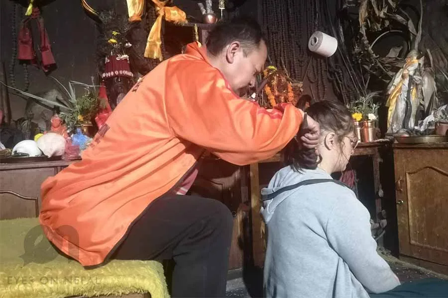 Shaman treating patient for backache